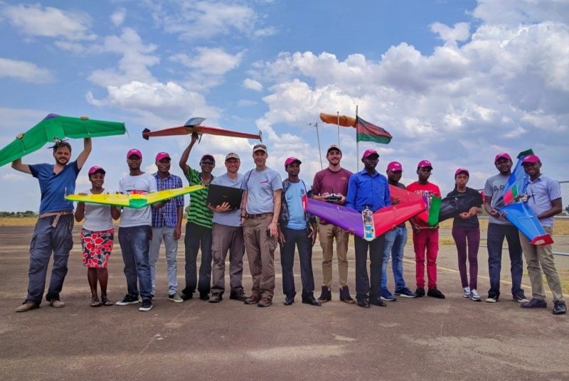 Students from the ADDA hold up their completed EcoSoar drones along with members of the Unmanned Systems Lab
